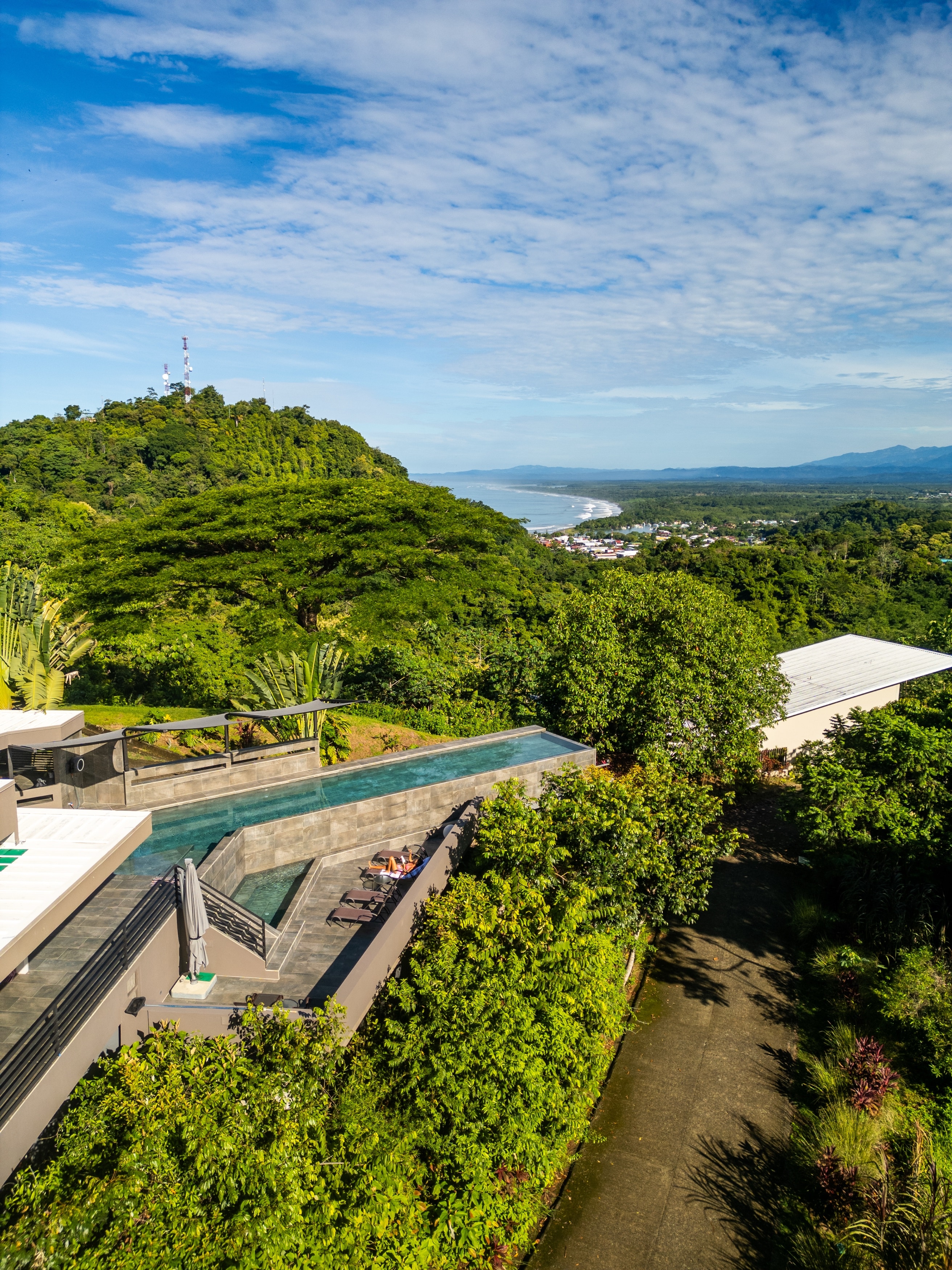 The lap pool, the canopy, and the Pacific coastline in the distance