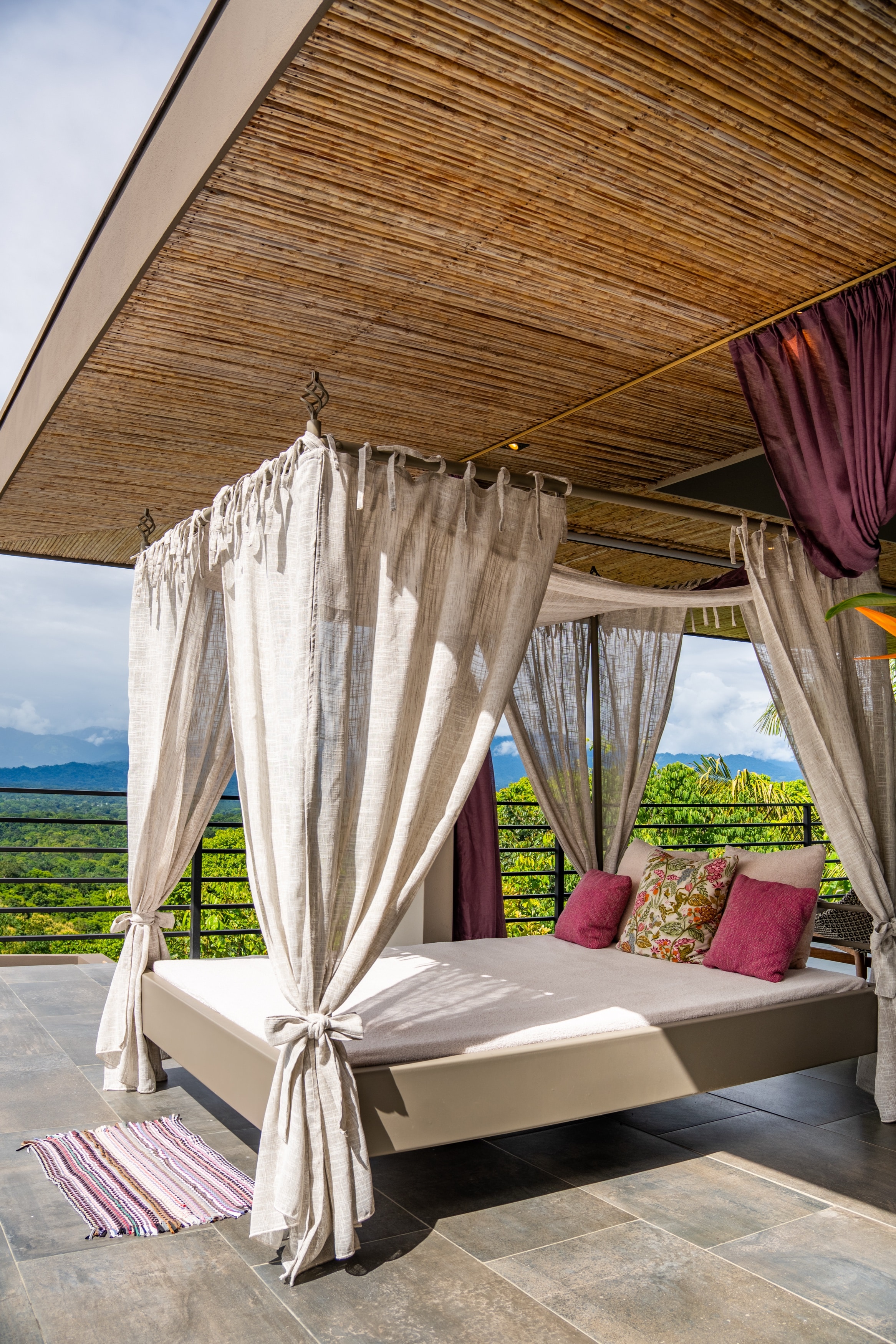 The canopy daybed on the covered terrace, under the bamboo ceiling